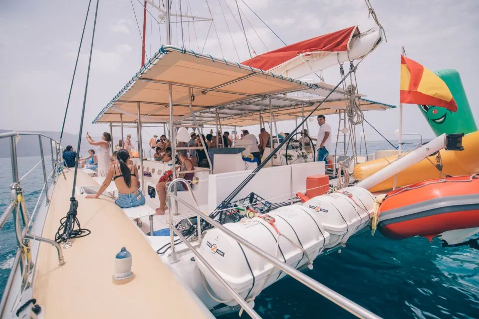 Passengers aboard a sailing catamaran off the coast of La Graciosa
